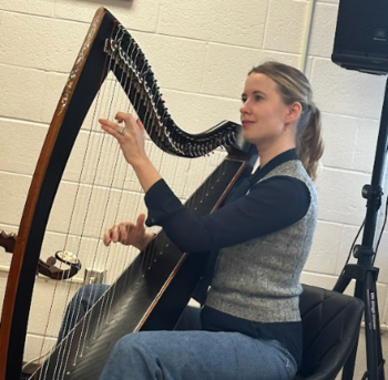 Harpist, Maeve Gilchrist performs for Fairfax Academy students.
